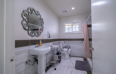 Bright and accessible bathroom at Trinity Hills Estates, a senior living care home in Arcadia, California, designed for comfort and safety of residents