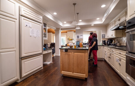 Dedicated staff in the kitchen at Trinity Hills Estates, a senior living care home in Arcadia, California, preparing nutritious meals for residents